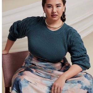 Sweater with novelty stitch sleeve